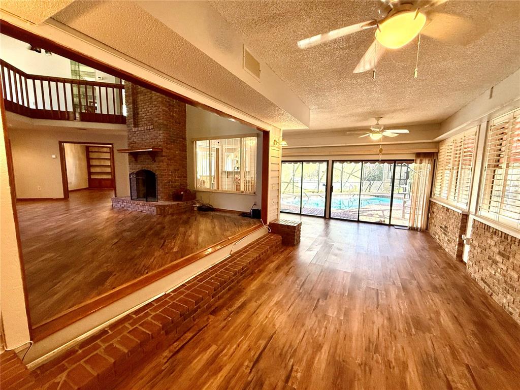 2395 Windward Cove Kissimmee, FL 34746 - Photo 15 of 62 a view of an empty room with wooden floor and a window