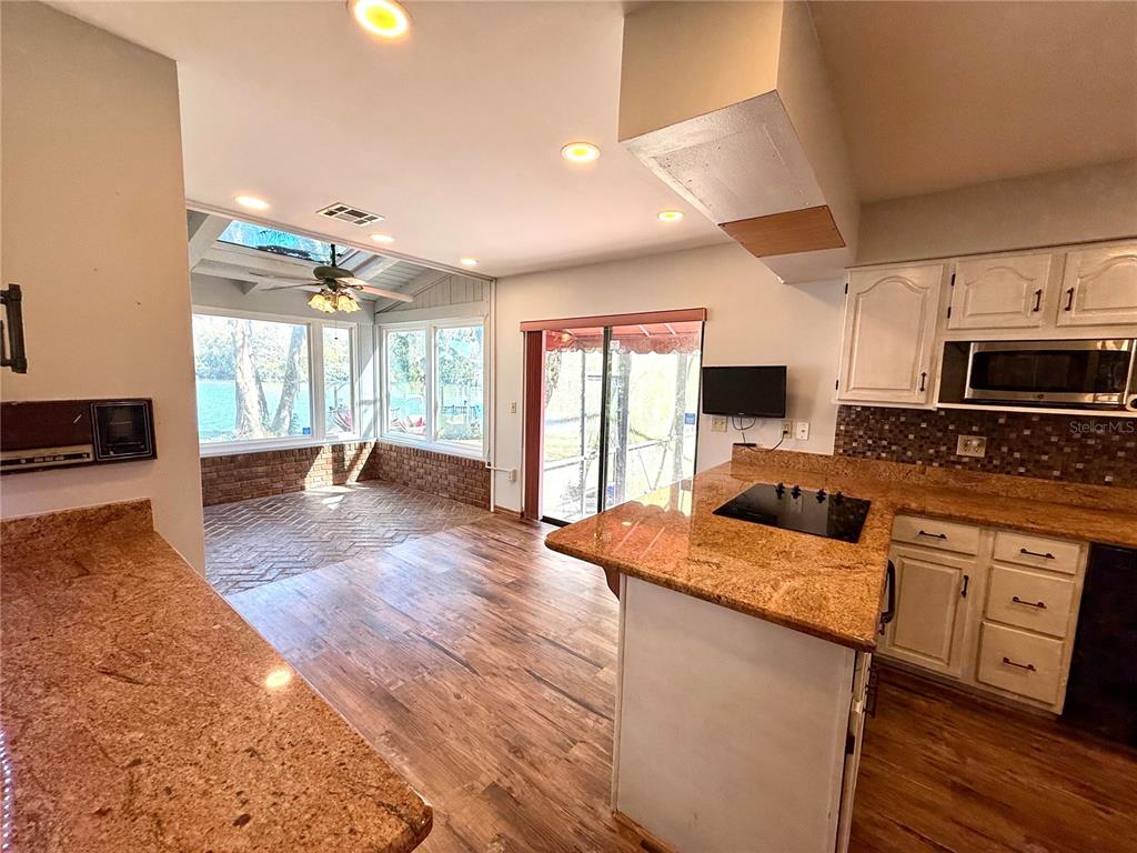 2395 Windward Cove Kissimmee, FL 34746 - Photo 17 of 62 a kitchen with stainless steel appliances granite countertop a sink stove and refrigerator