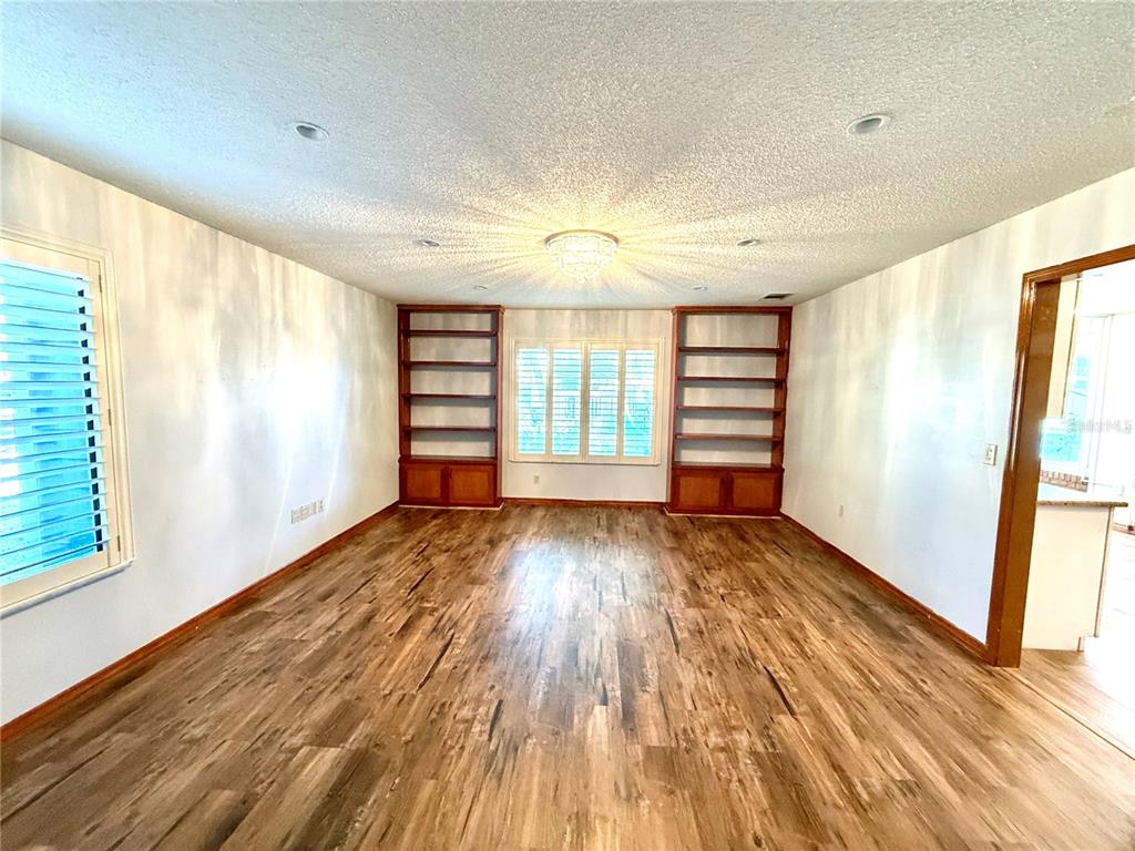 2395 Windward Cove Kissimmee, FL 34746 - Photo 19 of 62 a view of empty room with wooden floor and fan