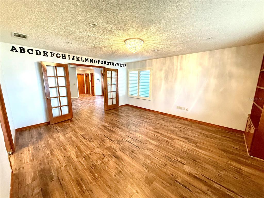 2395 Windward Cove Kissimmee, FL 34746 - Photo 20 of 62 wooden floor in an empty room with a window