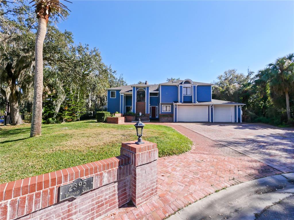 2395 Windward Cove Kissimmee, FL 34746 - Photo 2 of 62 a front view of a house with garden