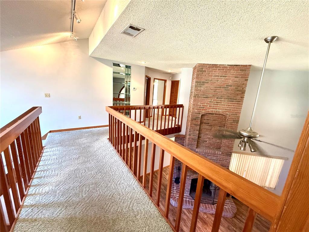 2395 Windward Cove Kissimmee, FL 34746 - Photo 22 of 62 a view of staircase with railing and white walls