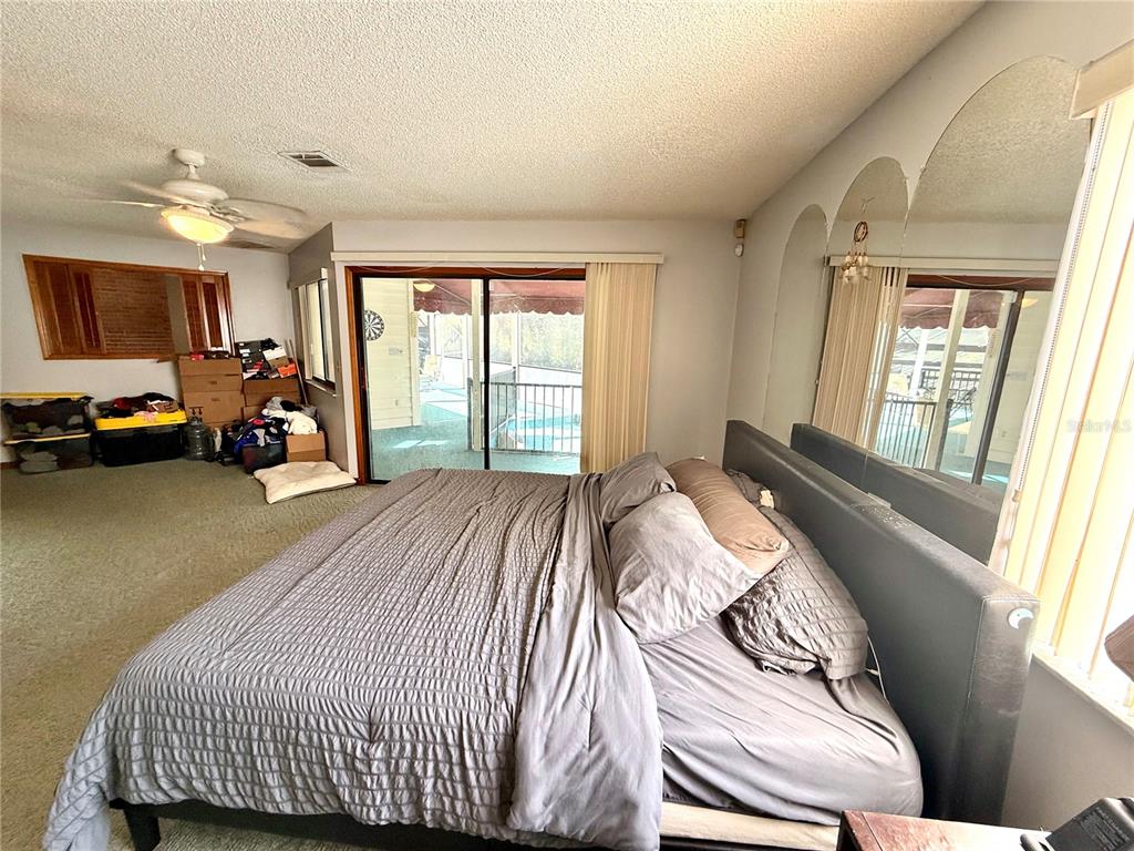 2395 Windward Cove Kissimmee, FL 34746 - Photo 30 of 62 a bed sitting in a bedroom next to a window