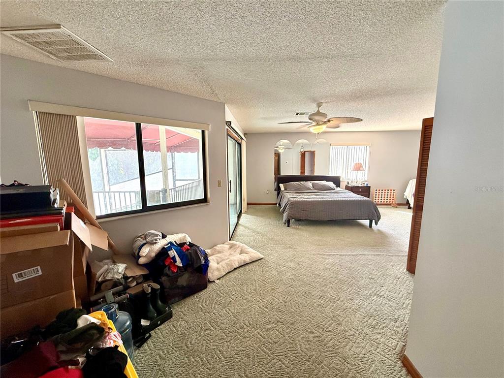 2395 Windward Cove Kissimmee, FL 34746 - Photo 31 of 62 a living room with furniture and a chandelier