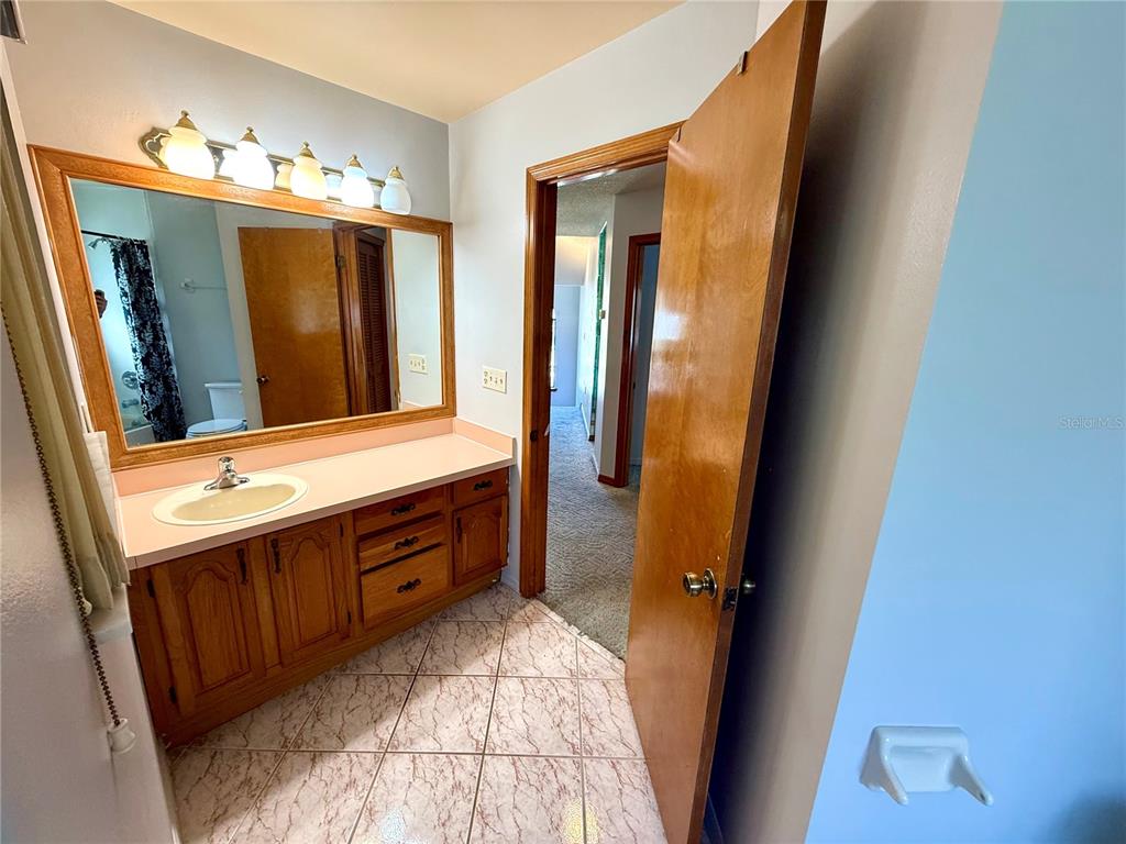 2395 Windward Cove Kissimmee, FL 34746 - Photo 38 of 62 a bathroom with a sink and a mirror