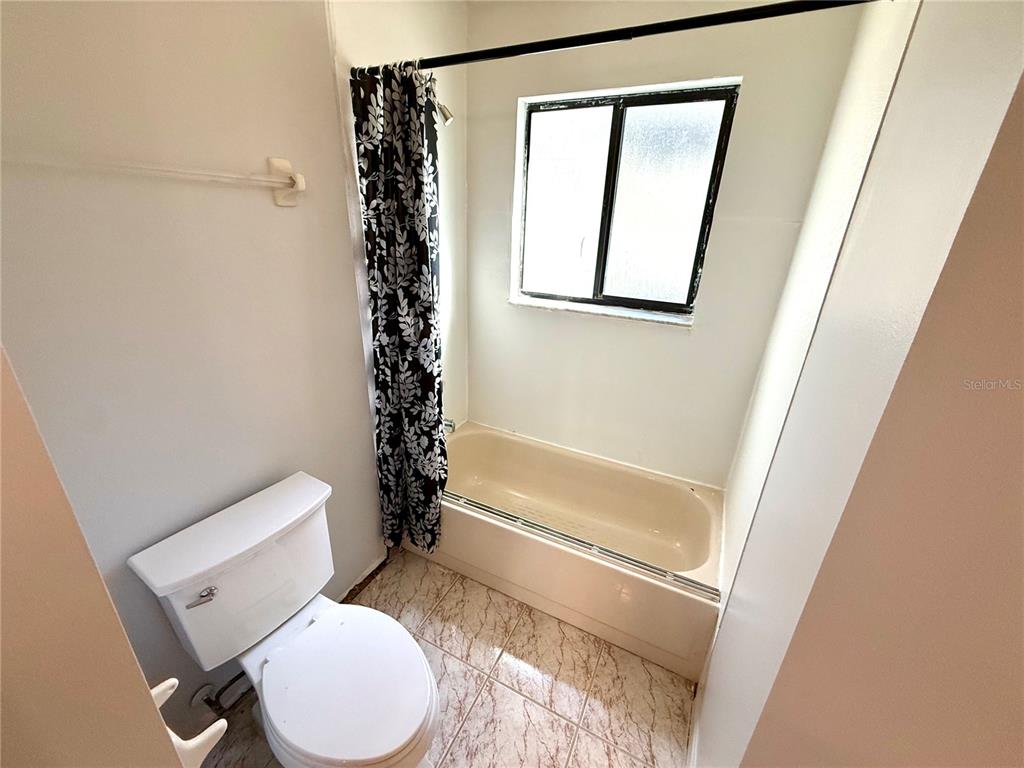 2395 Windward Cove Kissimmee, FL 34746 - Photo 40 of 62 a bathroom with a toilet and a shower