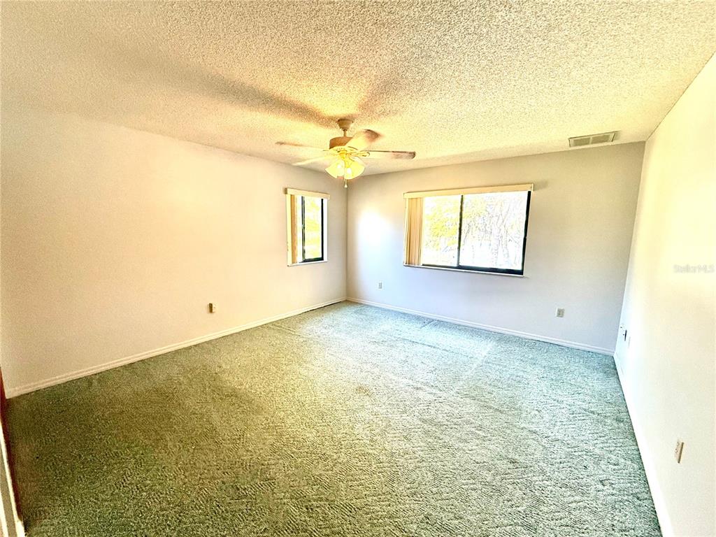 2395 Windward Cove Kissimmee, FL 34746 - Photo 41 of 62 a view of a big room with windows and chandelier fan