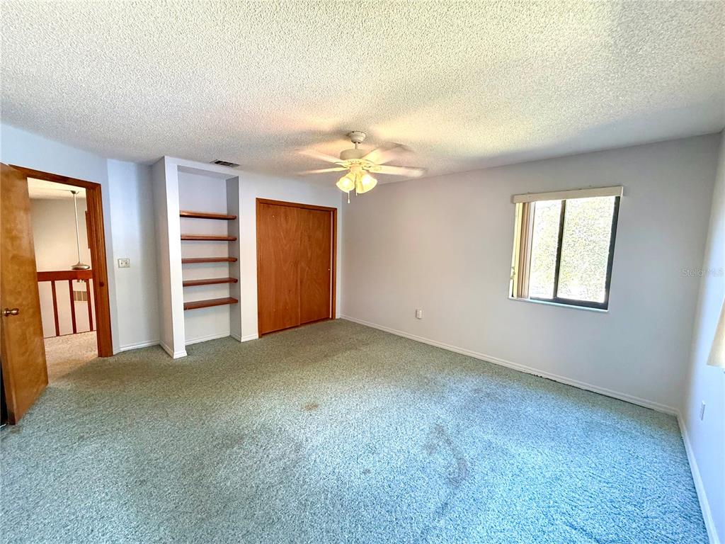 2395 Windward Cove Kissimmee, FL 34746 - Photo 42 of 62 an empty room with closet and a ceiling fan