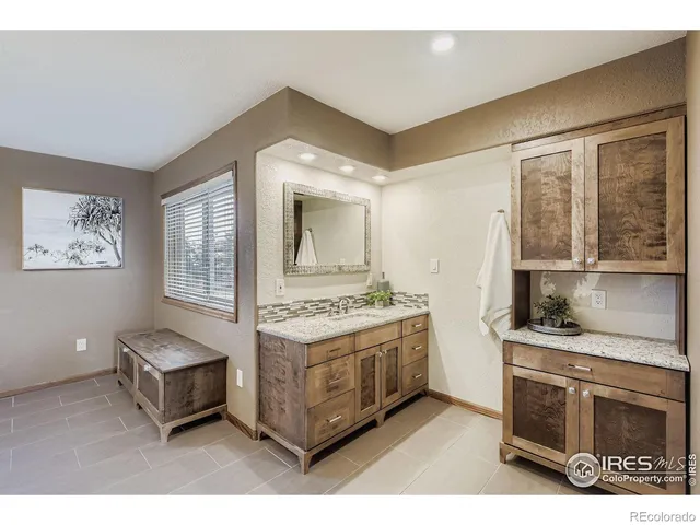 a living room with stainless steel appliances kitchen island granite countertop a stove and a cabinet