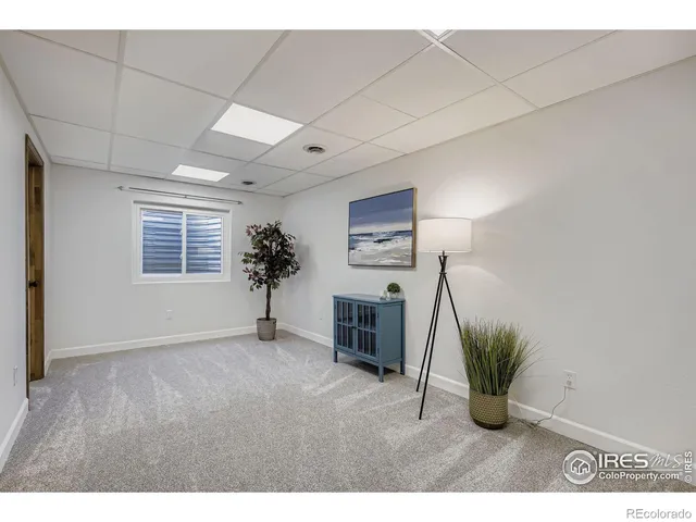 a view of livingroom with furniture and a potted plant