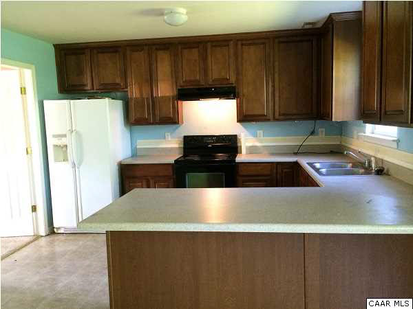 114 Apple Orchard Road Louisa, VA 23093 - Photo 6 of 8 a kitchen with kitchen island granite countertop a refrigerator a stove and a sink