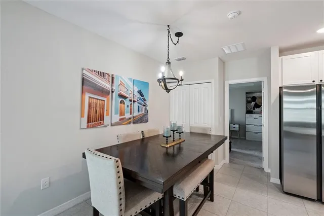 a kitchen with a table and refrigerator