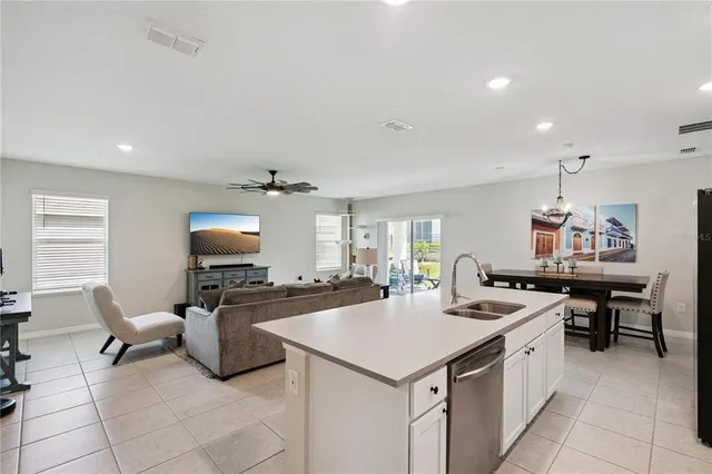 a kitchen with a stove a sink and a refrigerator