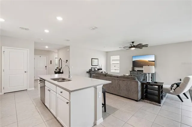 a kitchen that has a lot of cabinets in it and wooden floor