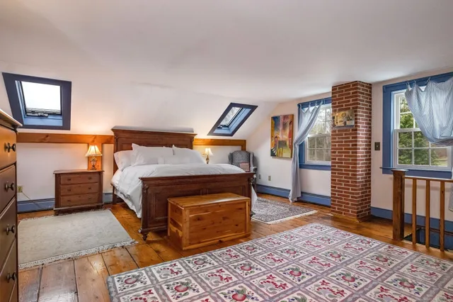 a bedroom with furniture and a rug