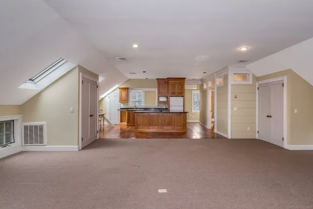 a view of empty room with wooden floor and windows