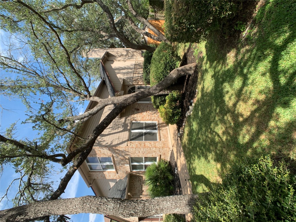 7712 Earp Way Austin, TX 78729 - Photo 2 of 40 a view of a white house next to a yard with a tree