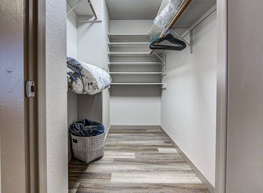 7712 Earp Way Austin, TX 78729 - Photo 22 of 40 a view of walk in closet with clothes and shoes