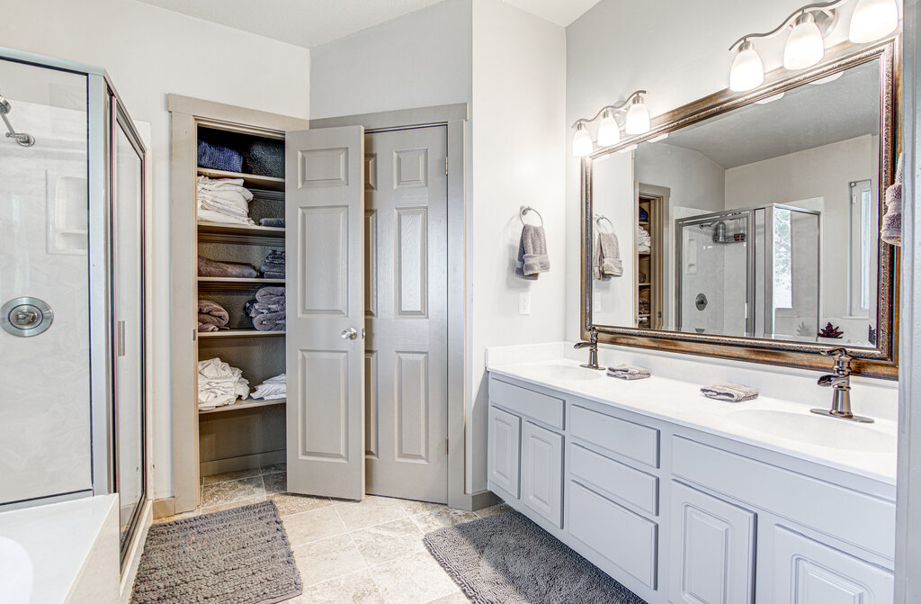 7712 Earp Way Austin, TX 78729 - Photo 23 of 40 a spacious bathroom with a double vanity sink and a mirror