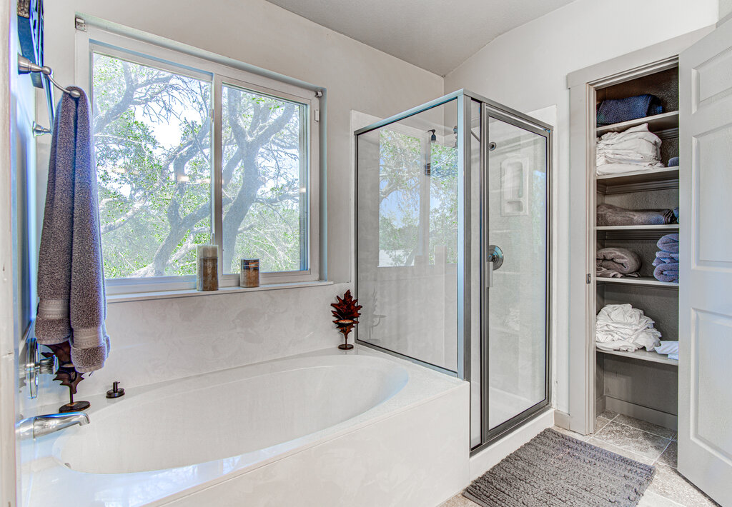 7712 Earp Way Austin, TX 78729 - Photo 24 of 40 a bathroom with a tub shower and a sink