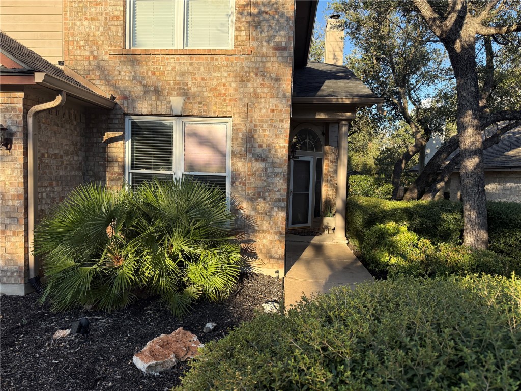 7712 Earp Way Austin, TX 78729 - Photo 3 of 40 a backyard of a house with lots of green space