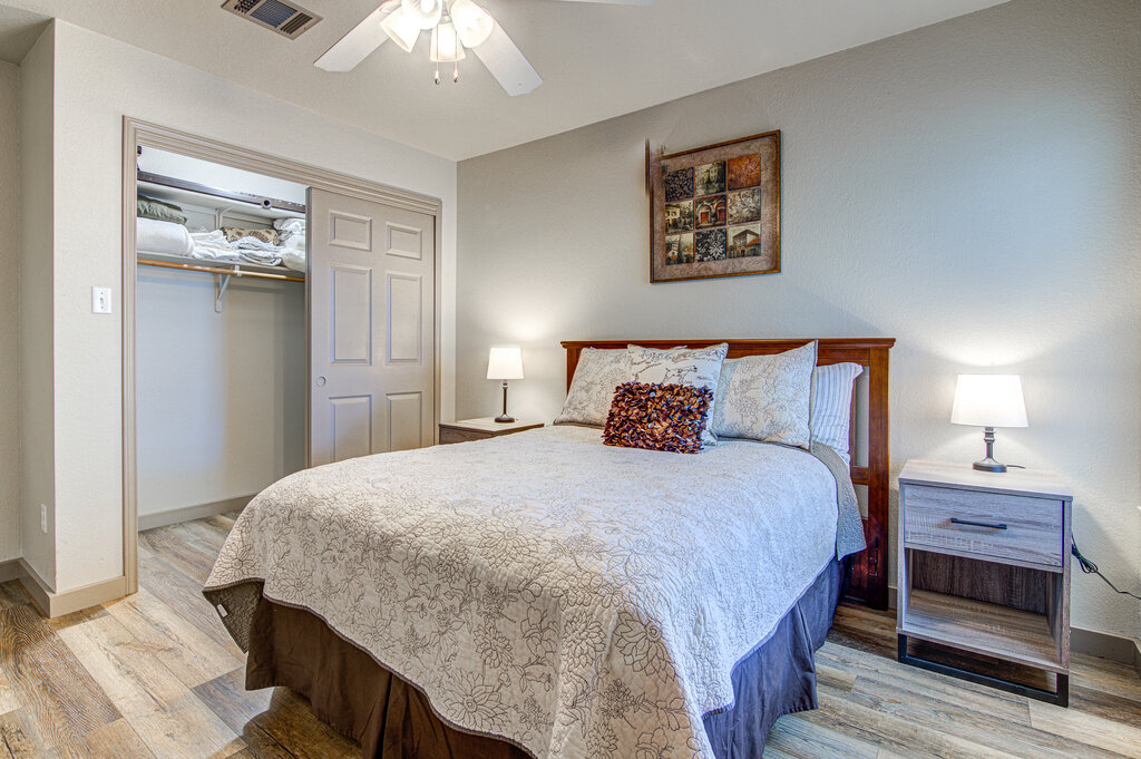 7712 Earp Way Austin, TX 78729 - Photo 34 of 40 a bedroom with a bed and a chandelier