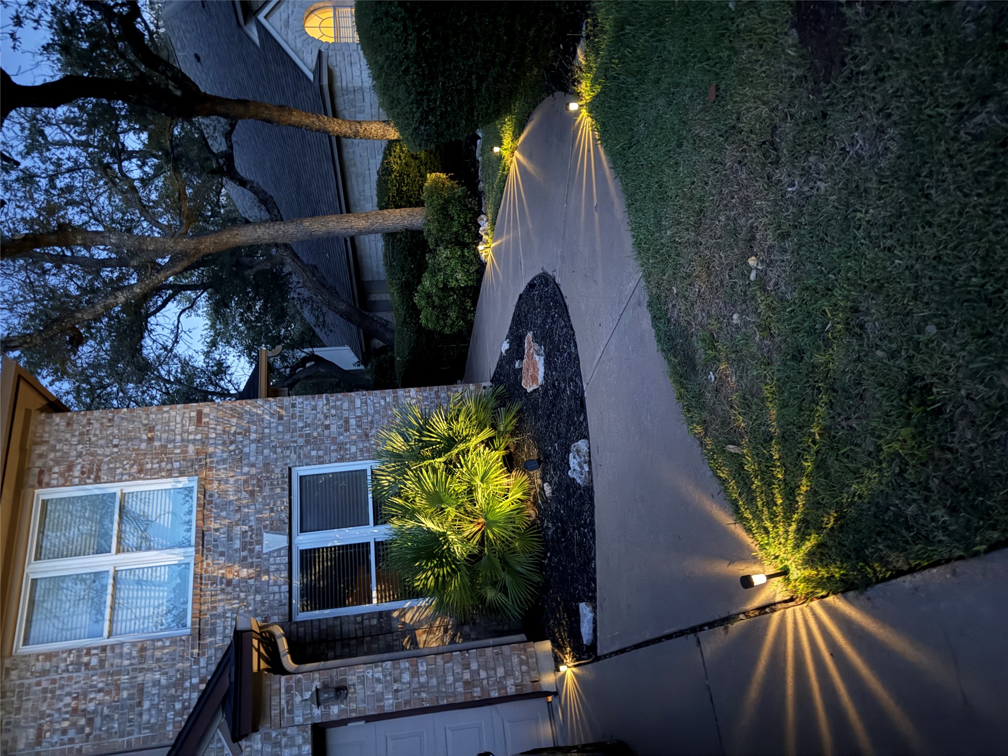 7712 Earp Way Austin, TX 78729 - Photo 7 of 40 a view of a house with a yard and a garden