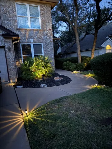 a view of a house with a yard and a garden
