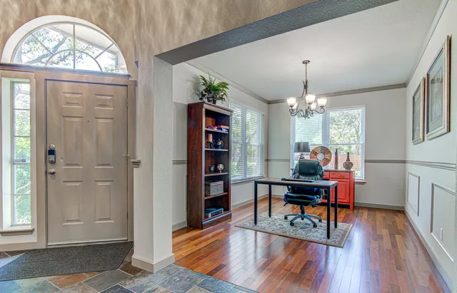 a view of a livingroom with furniture window and wooden floor