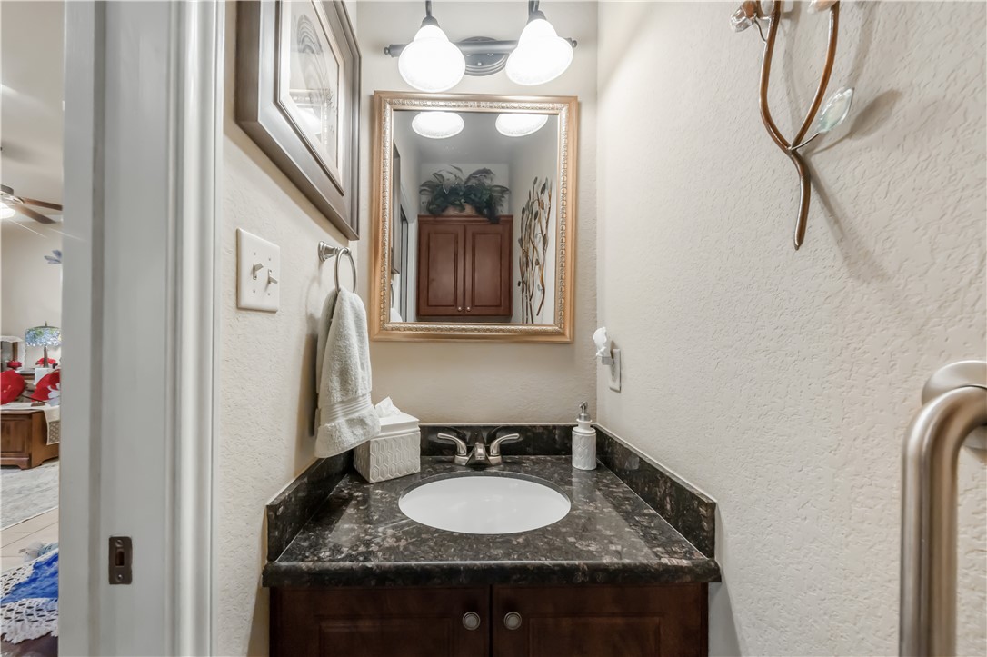 3815 Harvey Road College Station, TX 77845 - Photo 10 of 24 a bathroom with a granite countertop sink a mirror and a shower