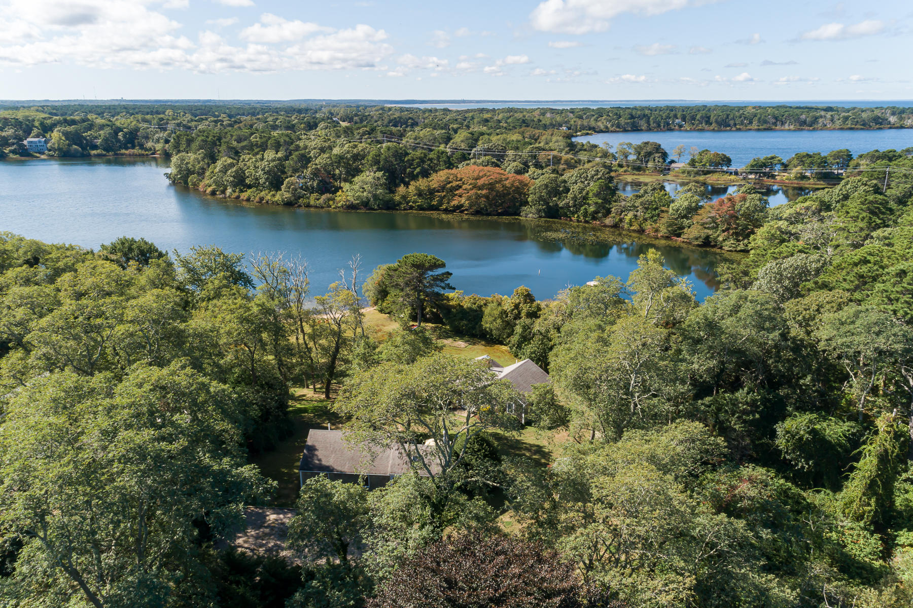 an aerial view of residential houses with outdoor space and lake view