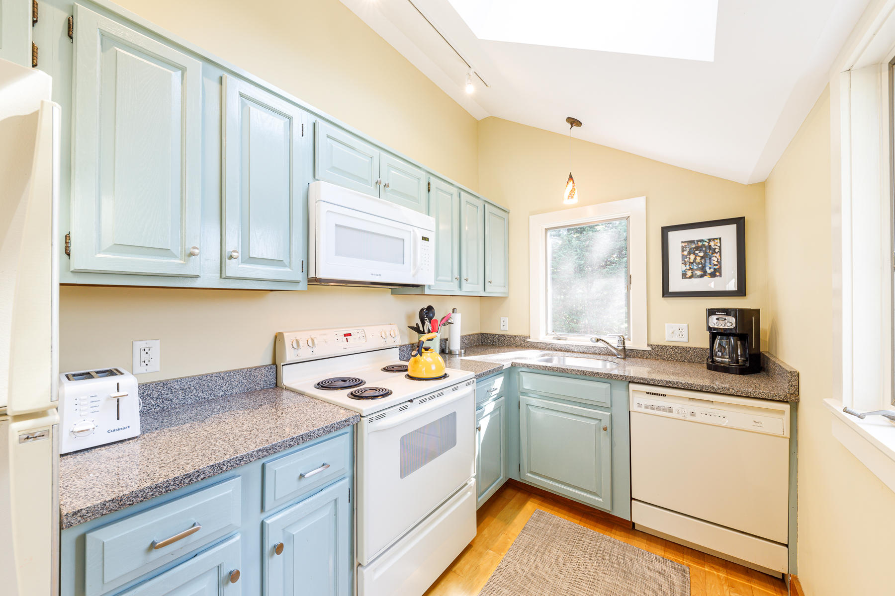 295 Mill Road Eastham, MA 02642 - Photo 14 of 33 a kitchen with a sink dishwasher a stove and white cabinets