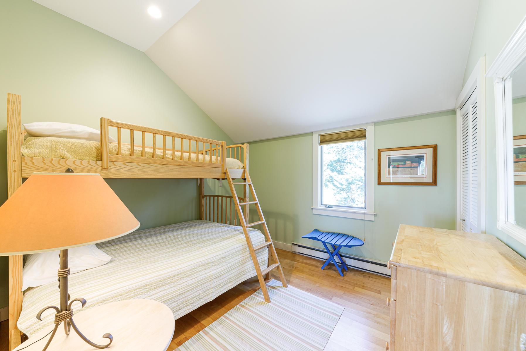 295 Mill Road Eastham, MA 02642 - Photo 15 of 33 a bedroom with a bed and wooden floor