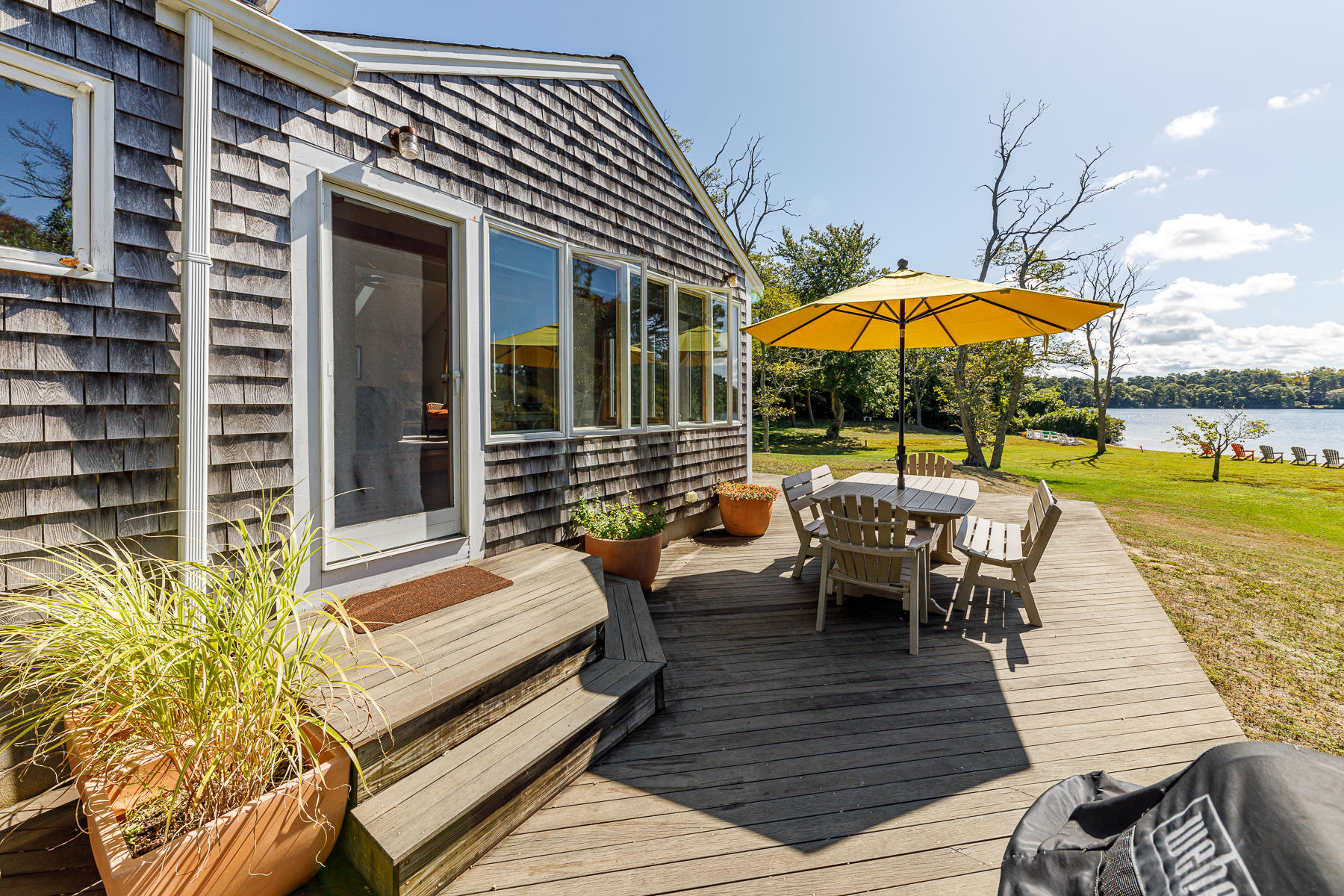 295 Mill Road Eastham, MA 02642 - Photo 22 of 33 an outdoor sitting area with furniture and umbrella