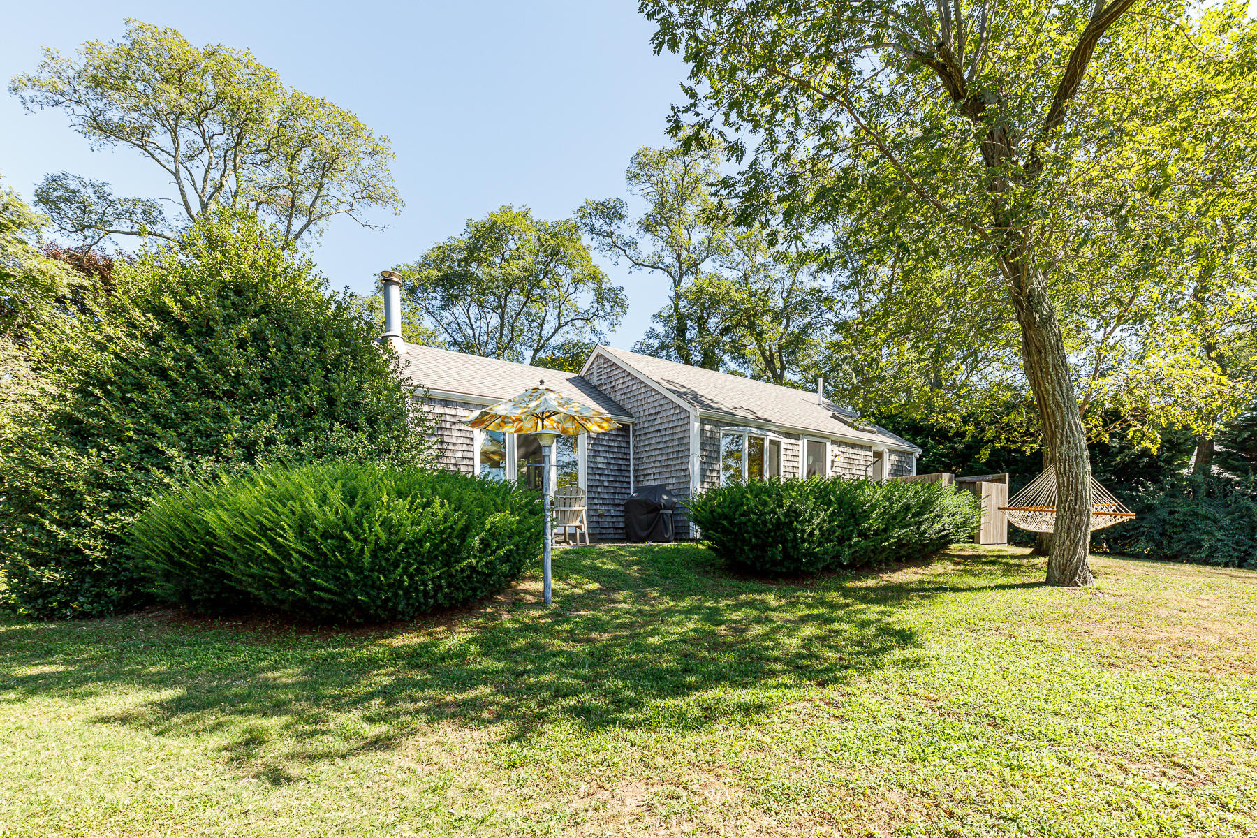 295 Mill Road Eastham, MA 02642 - Photo 3 of 33 a front view of a house with garden