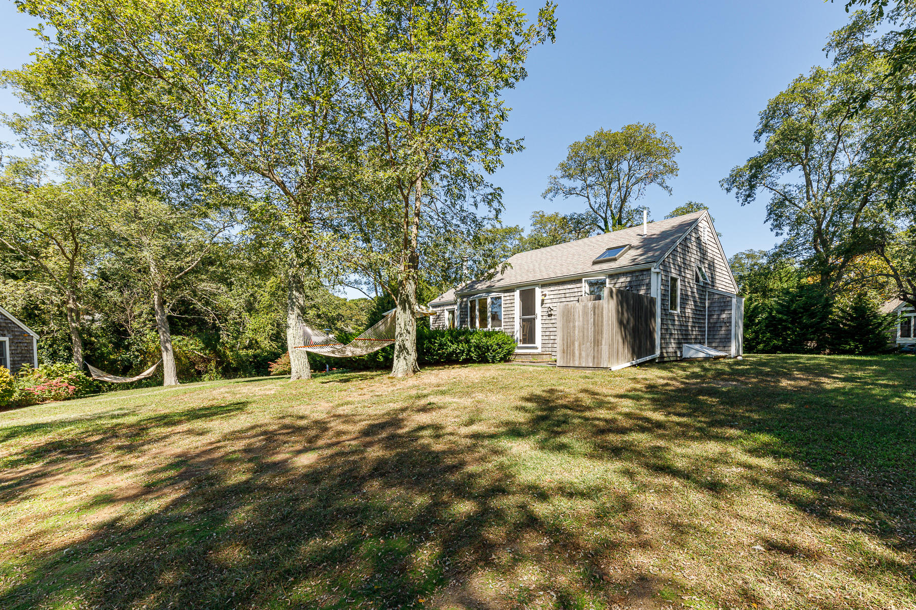 295 Mill Road Eastham, MA 02642 - Photo 7 of 33 a front view of a house with a garden