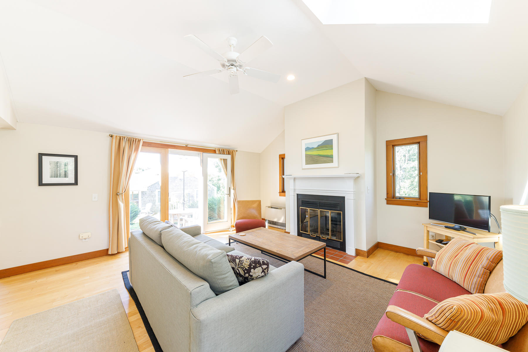 295 Mill Road Eastham, MA 02642 - Photo 9 of 33 a living room with furniture flat screen tv and a fireplace