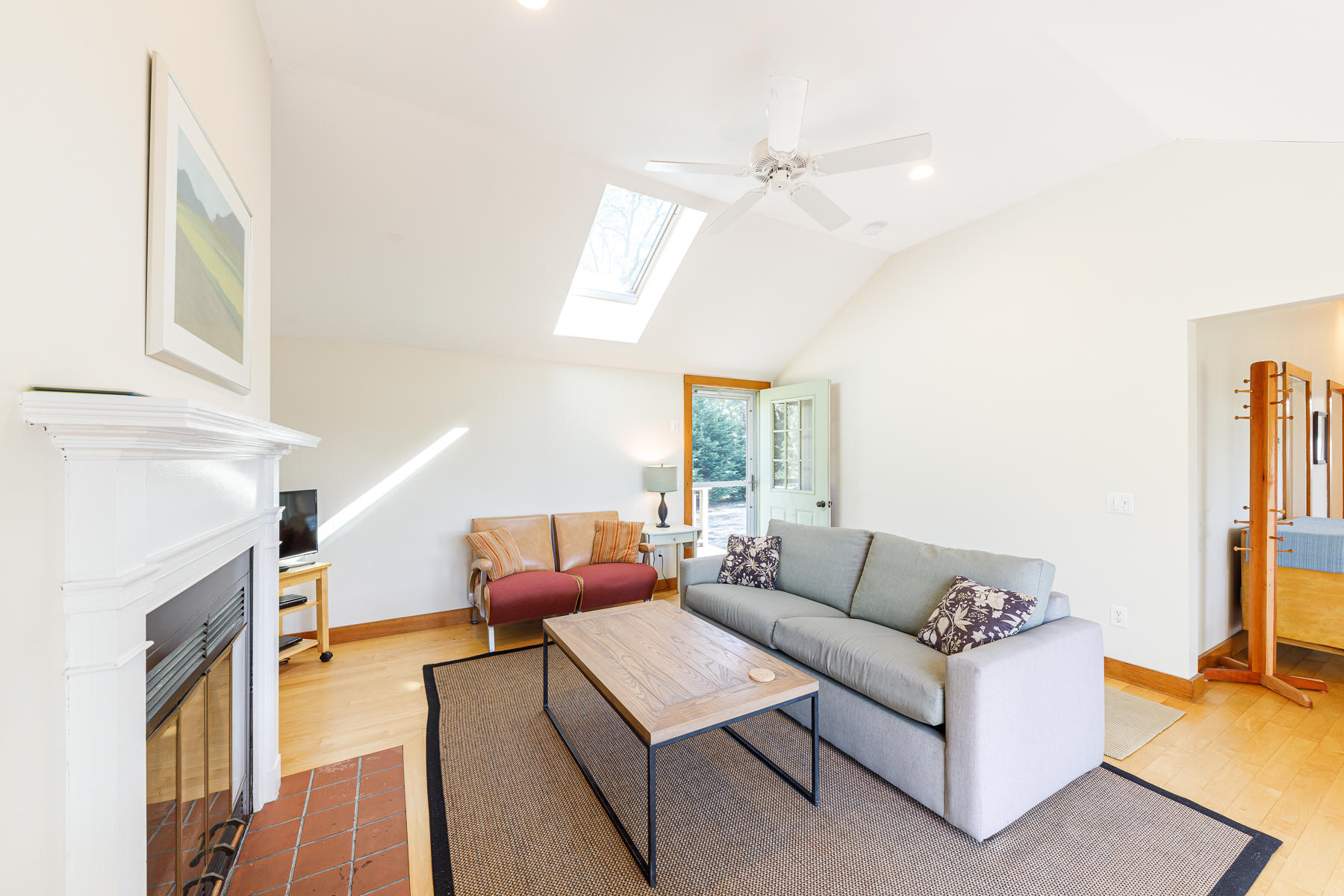 295 Mill Road Eastham, MA 02642 - Photo 10 of 33 a living room with furniture and a fireplace