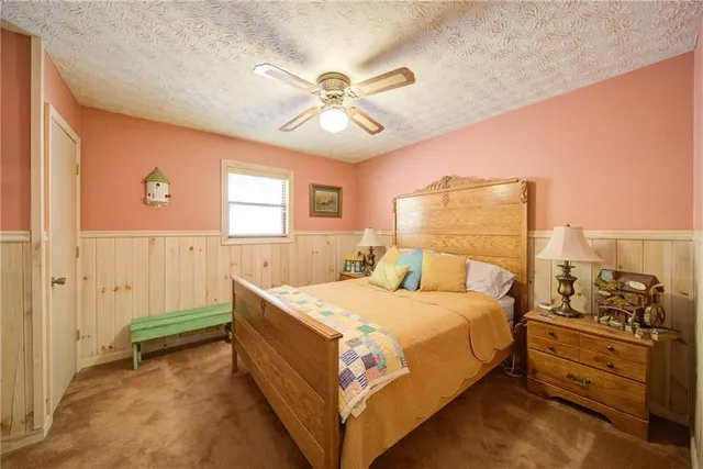 a view of a kitchen with stainless steel appliances wooden floor and living room view