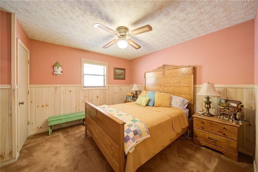 400 Matrix Circle Ellijay, GA 30540 - Photo 27 of 47 a bedroom with a bed and a chandelier