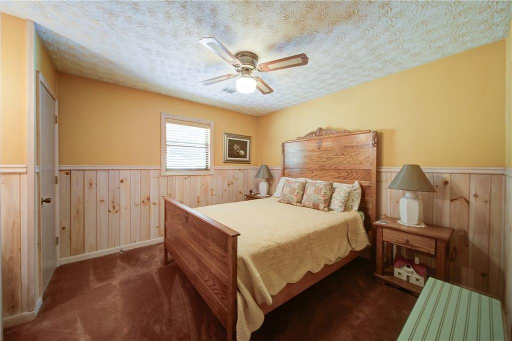 400 Matrix Circle Ellijay, GA 30540 - Photo 33 of 47 a bedroom with a bed and a chandelier