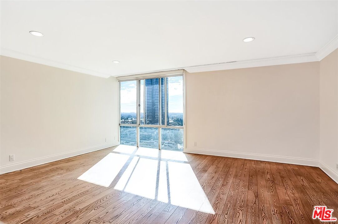 2160 Century Park East, Unit 1903 Los Angeles, CA 90067 - Photo 13 of 40 an empty room with wooden floor and windows