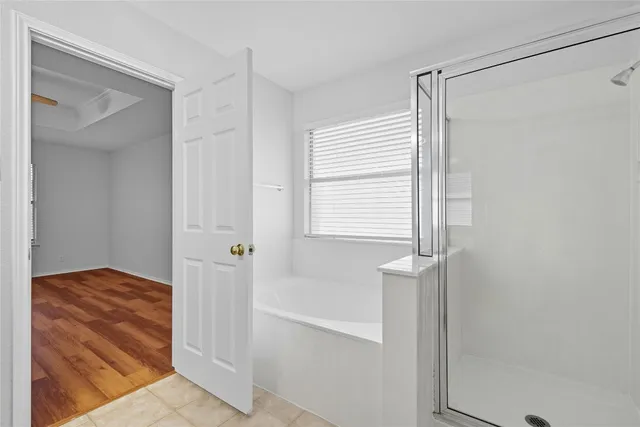 a bathroom with a bathtub and shower