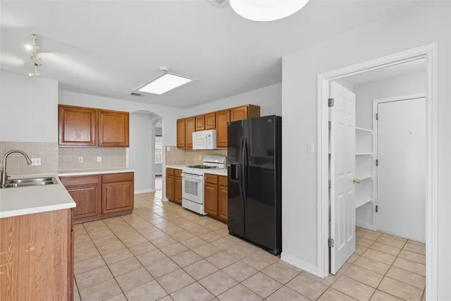 a kitchen with a refrigerator sink and stove