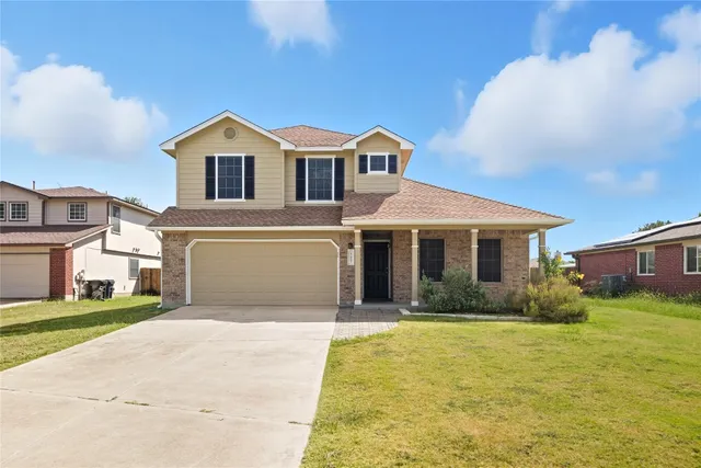 a front view of a house with a yard