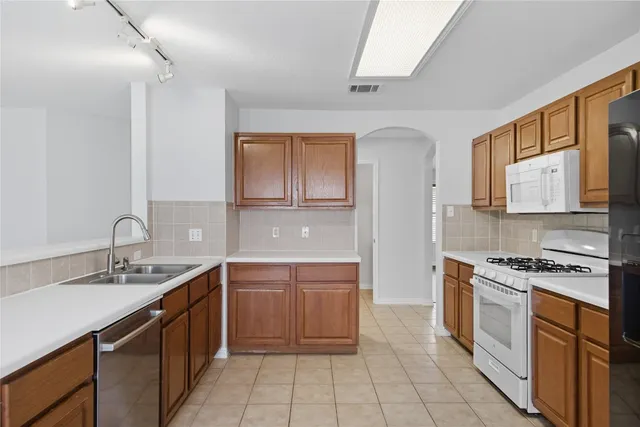 a kitchen with a sink stove and cabinets