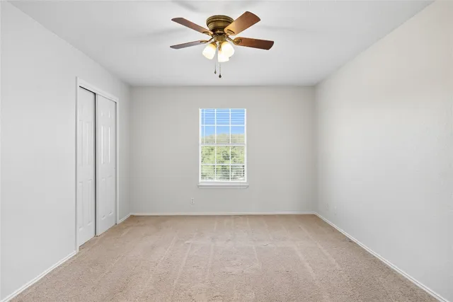 a view of a room with a window and a fan