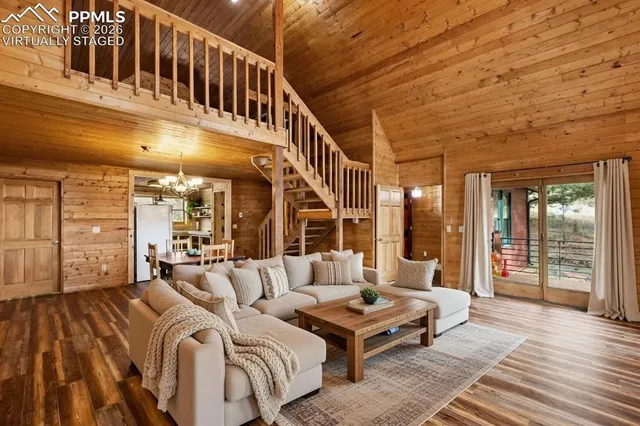 a balcony with furniture and wooden floor