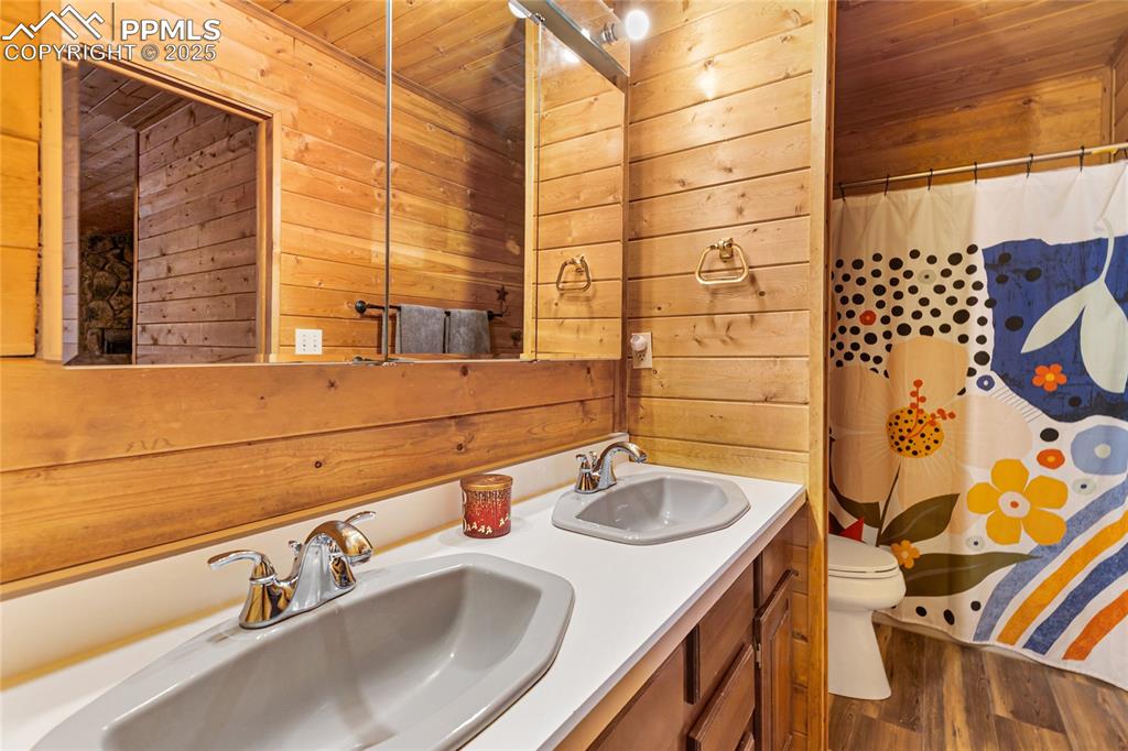 795 South Mountain Estates Road Florissant, CO 80816 - Photo 21 of 42 a bathroom with a sink and a mirror