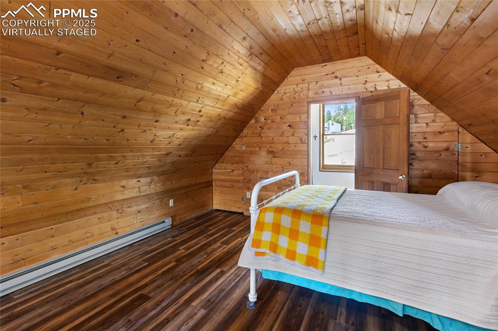 795 South Mountain Estates Road Florissant, CO 80816 - Photo 25 of 42 a bedroom with a bed and a window